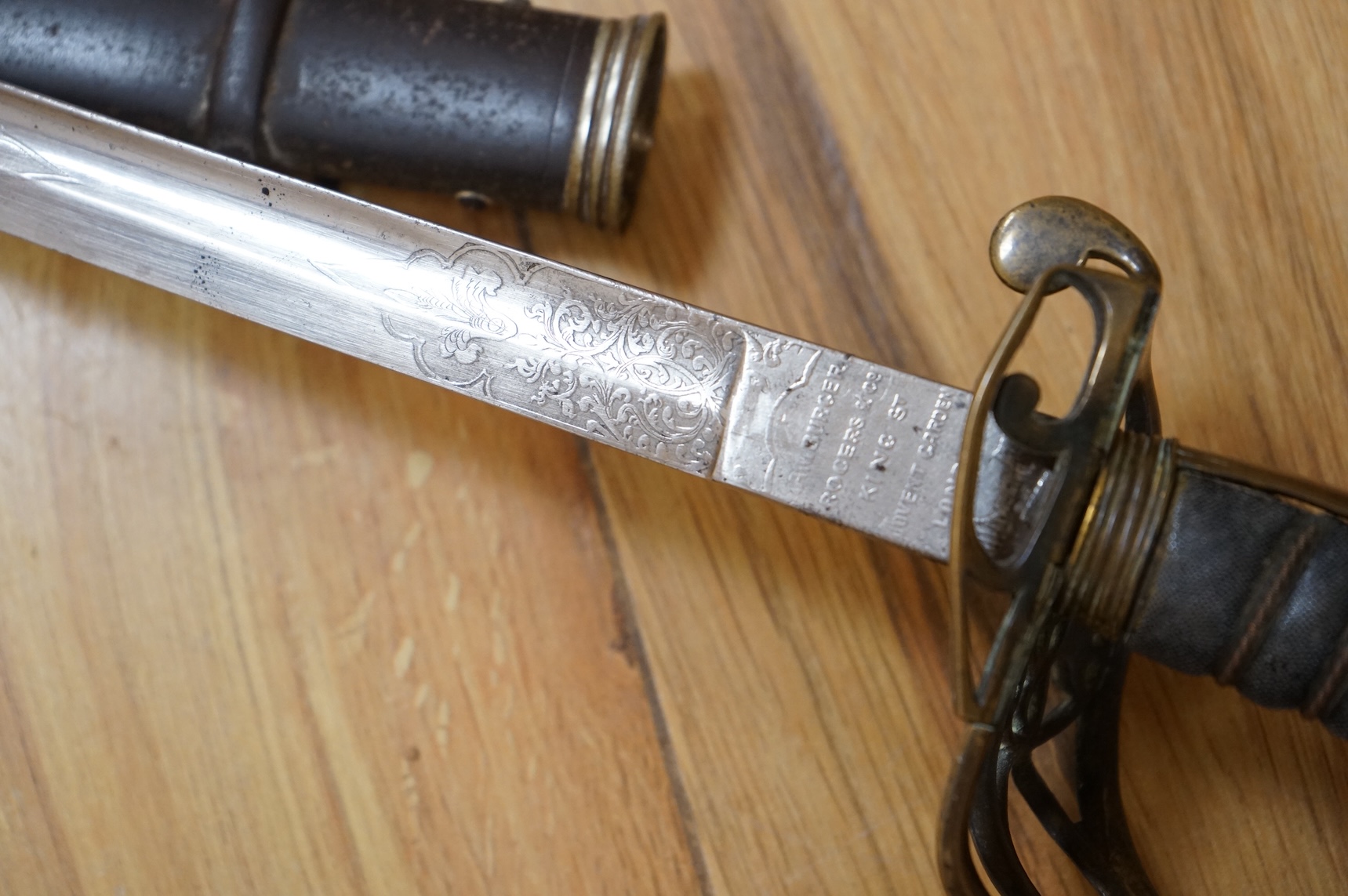 A Victorian 1845 pattern infantry officer’s levee sword, with slender blade etched; Hamburger Rogers & Co., and crowned VR and foliage, regulation pierced brass guard with folding side guard, wire bound fish skin covered